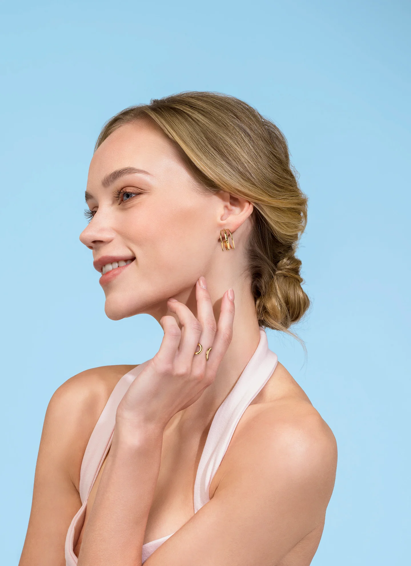 Modelo luciendo pendientes dorados de bisutería para regalar a mamá